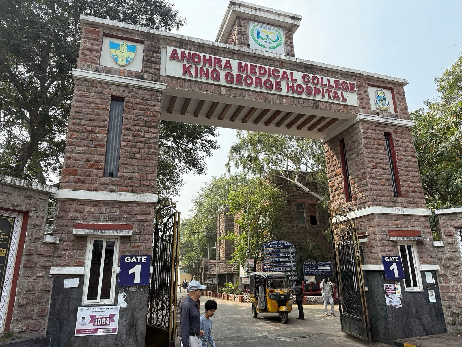 The stone entrance arch of Andhra Medical College and King George Hospital, with the college crest above the gate.